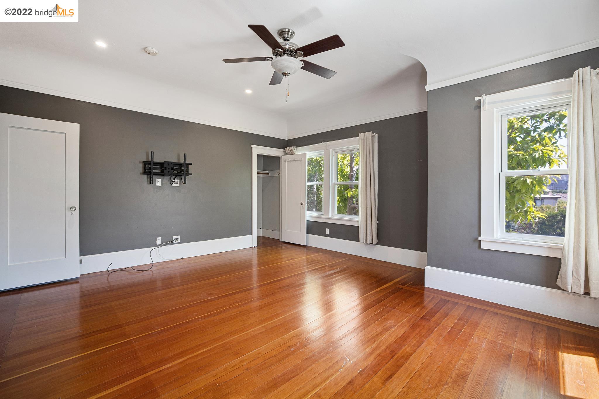 Undisclosed Address Berkeley, CA 94705 - Photo 13 of 28 a view of an empty room with window and wooden floor