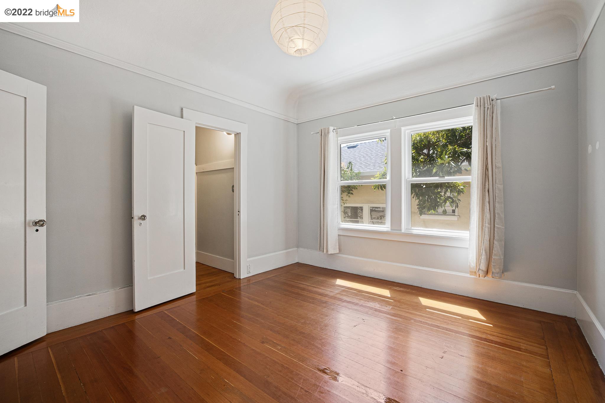 Undisclosed Address Berkeley, CA 94705 - Photo 17 of 28 a view of an empty room with wooden floor and a window