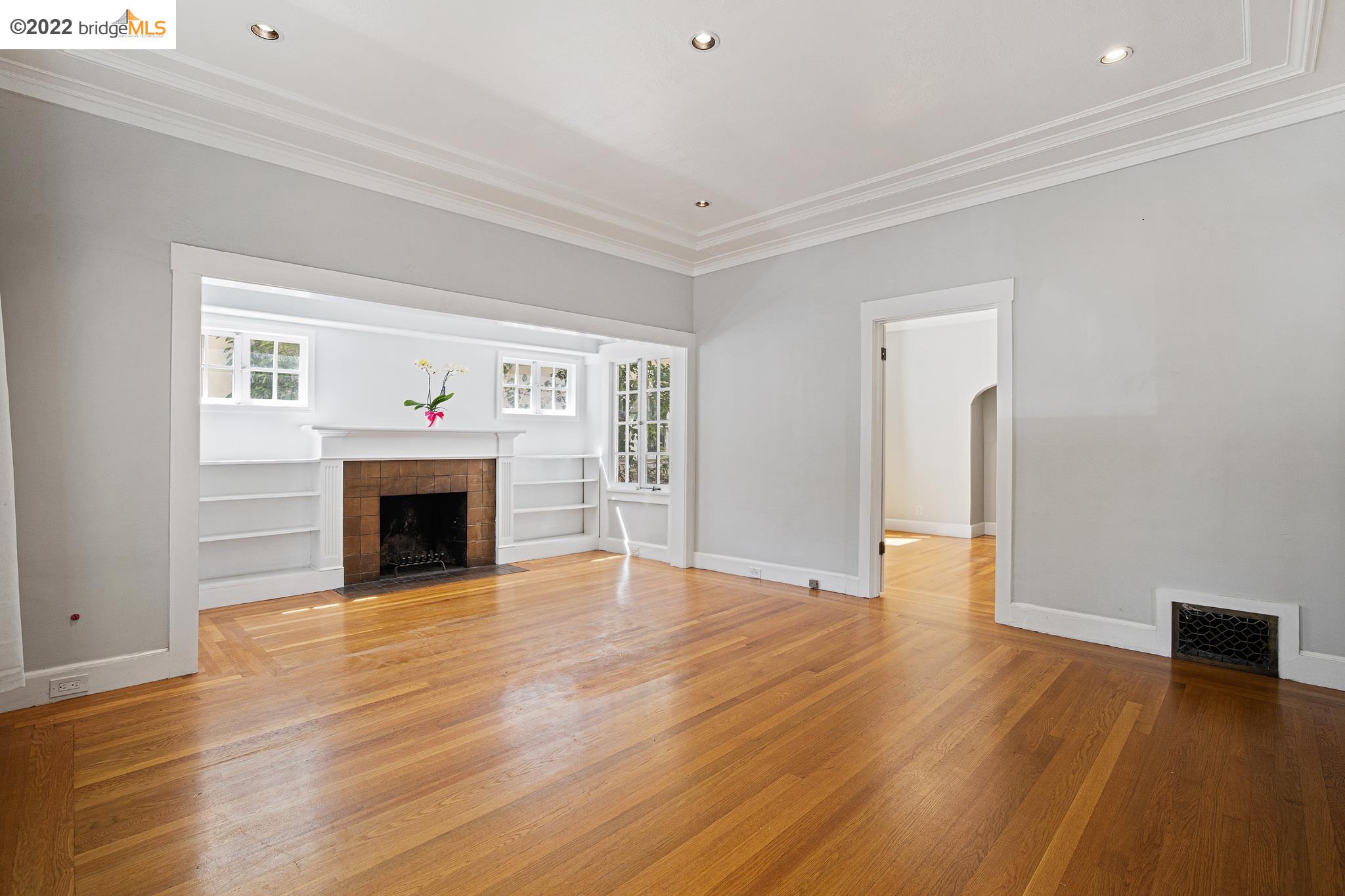 Undisclosed Address Berkeley, CA 94705 - Photo 3 of 28 a view of empty room with wooden floor and fireplace