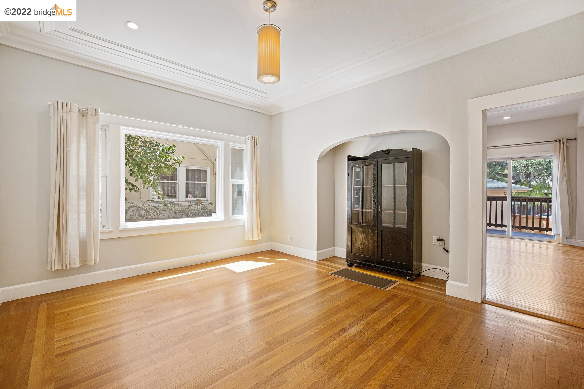 Undisclosed Address Berkeley, CA 94705 - Photo 5 of 28 an empty room with wooden floor and windows