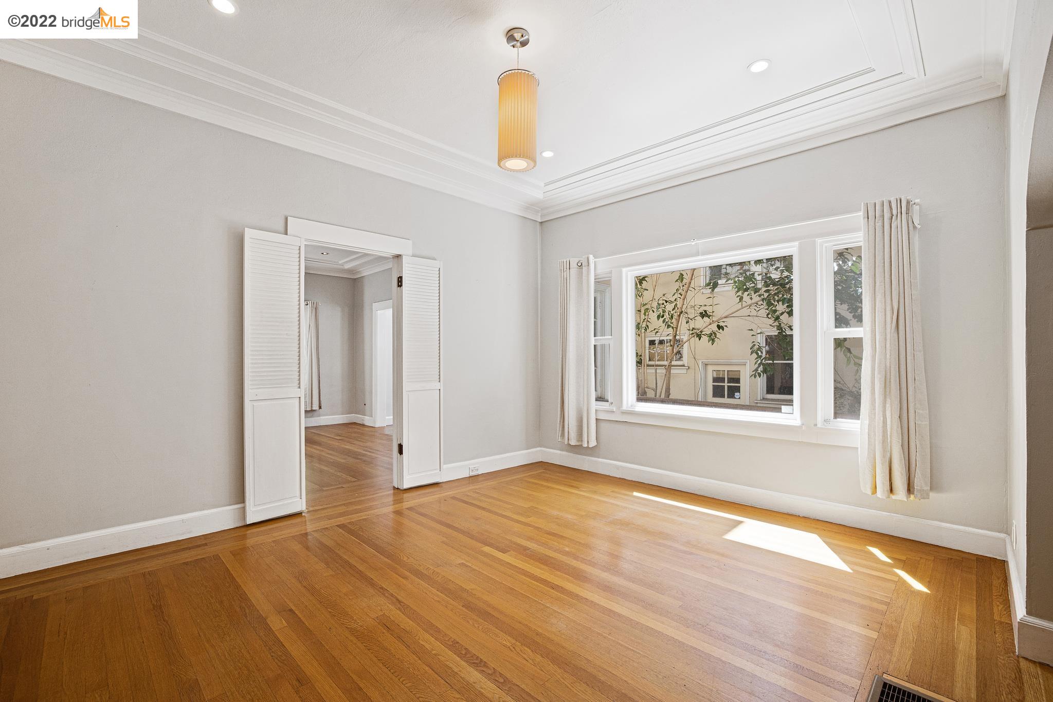 Undisclosed Address Berkeley, CA 94705 - Photo 6 of 28 a view of an empty room with window and wooden floor