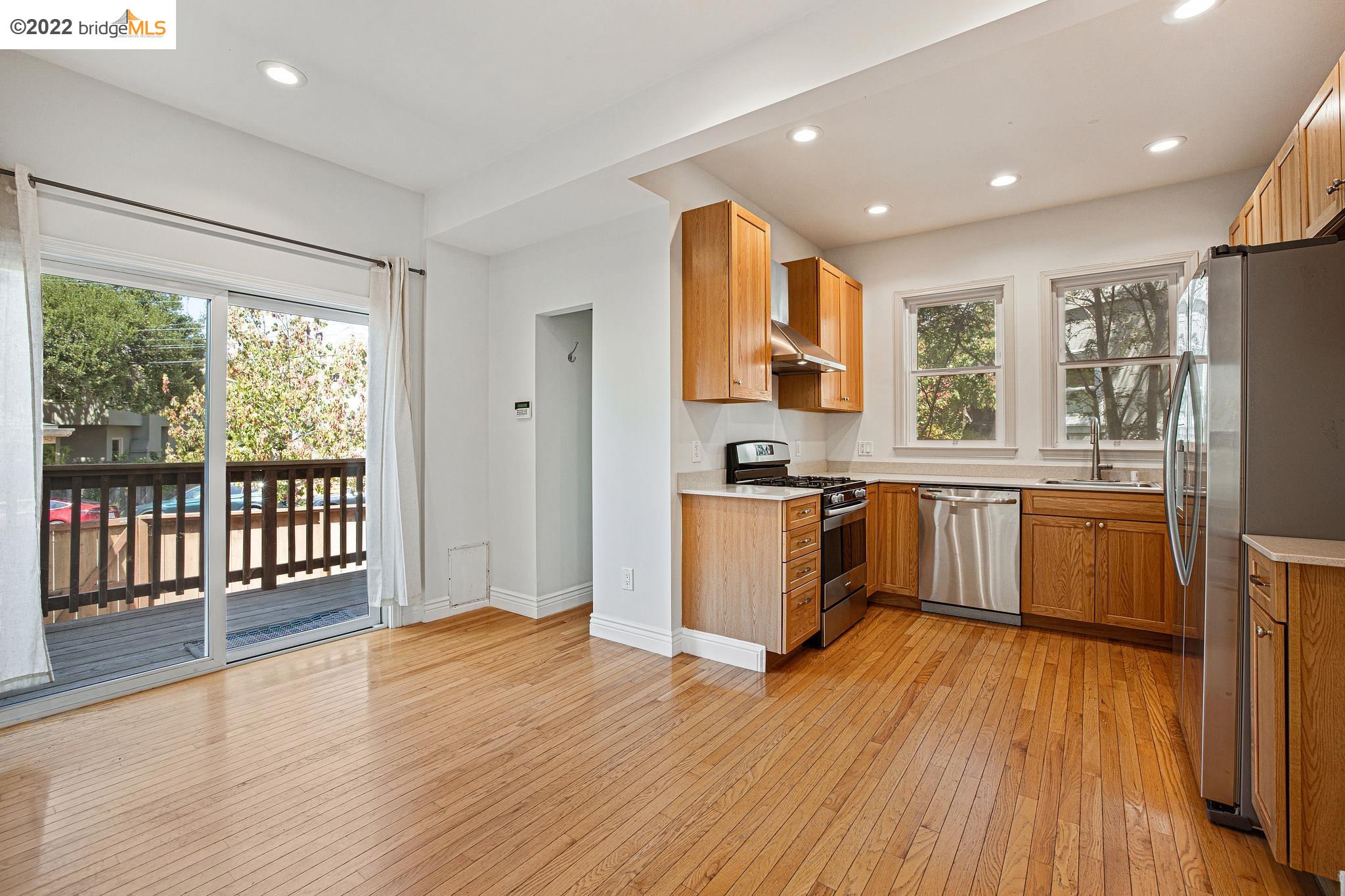Undisclosed Address Berkeley, CA 94705 - Photo 7 of 28 a kitchen with stainless steel appliances granite countertop a refrigerator a sink dishwasher a stove and white countertops with wooden floor