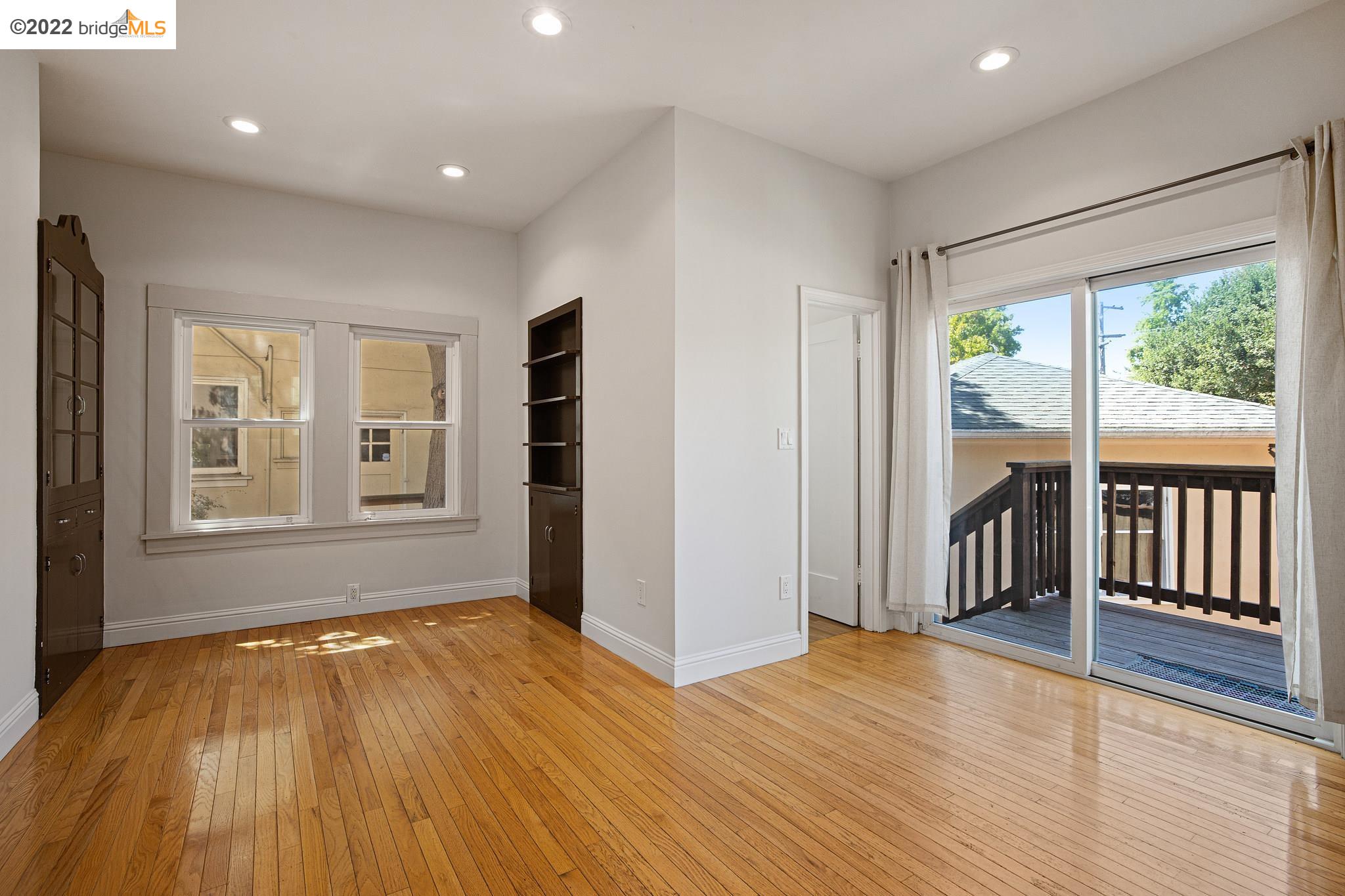 Undisclosed Address Berkeley, CA 94705 - Photo 9 of 28 an empty room with wooden floor and windows