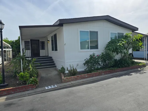 front view of a house with potted plants