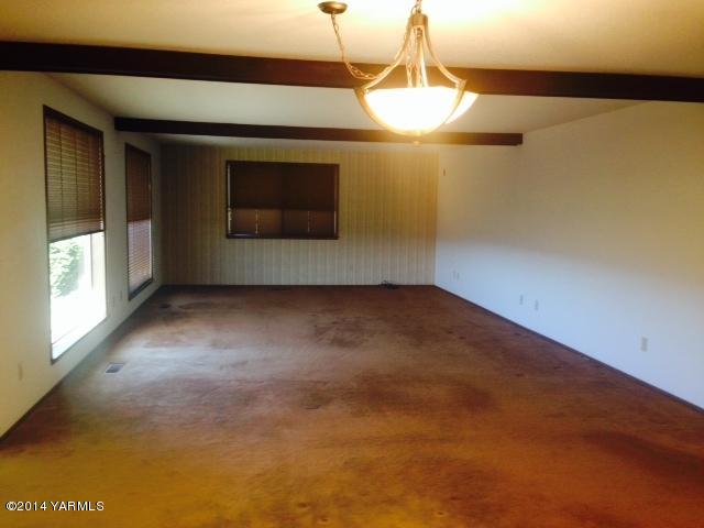 806 Estes Road Yakima, WA 98908 - Photo 4 of 12 a view of empty room with a fireplace