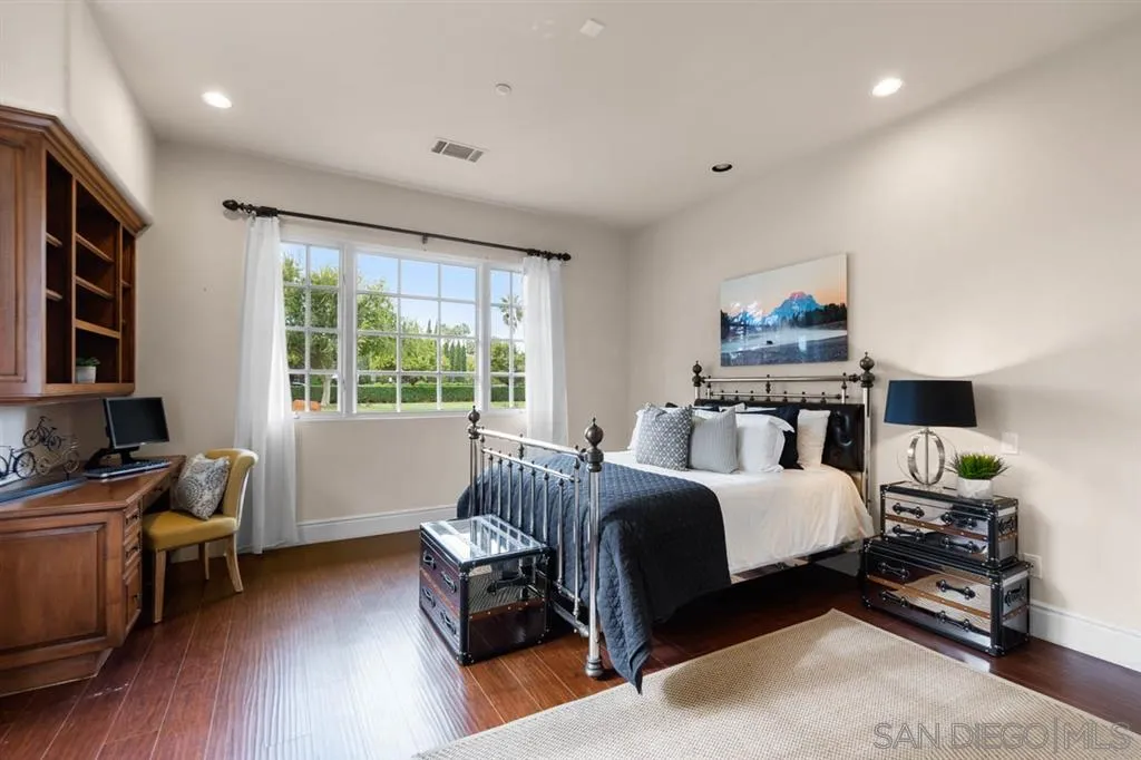 15611 Via De Santa Fe Rancho Santa Fe, CA 92067 - Photo 16 of 25 a bed room with a bed and a chair