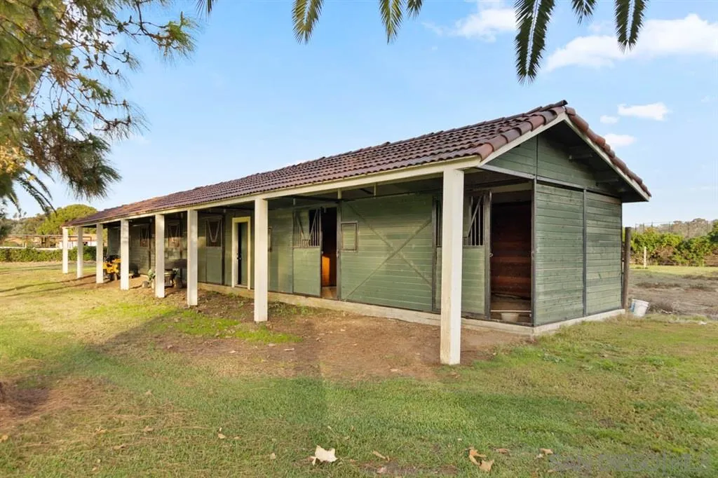 15611 Via De Santa Fe Rancho Santa Fe, CA 92067 - Photo 22 of 25 a front view of a house with a yard