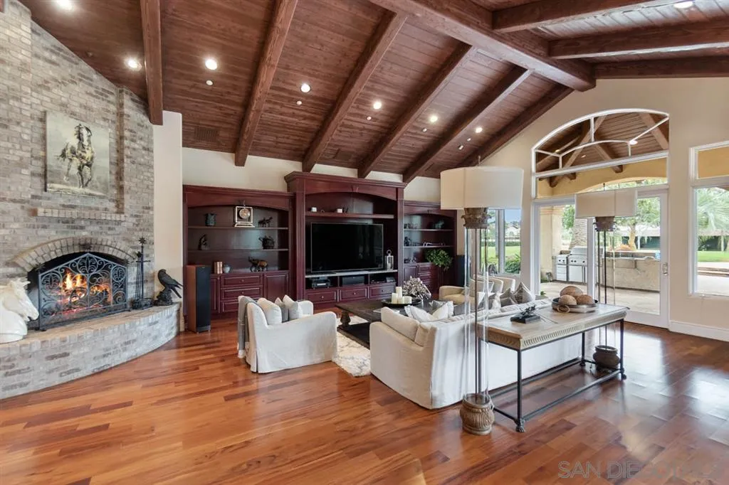 15611 Via De Santa Fe Rancho Santa Fe, CA 92067 - Photo 6 of 25 a living room with furniture and a fireplace