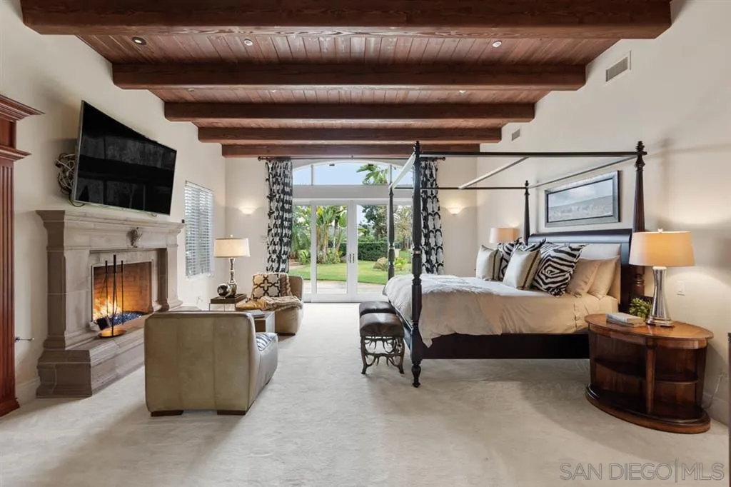 15611 Via De Santa Fe Rancho Santa Fe, CA 92067 - Photo 8 of 25 a living room with furniture and a fireplace