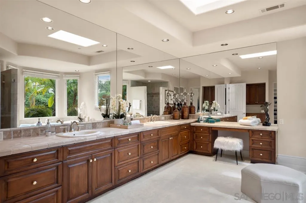 15611 Via De Santa Fe Rancho Santa Fe, CA 92067 - Photo 9 of 25 a large kitchen with sink and wooden cabinets