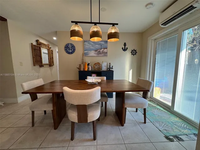 a view of a dining room with furniture and window