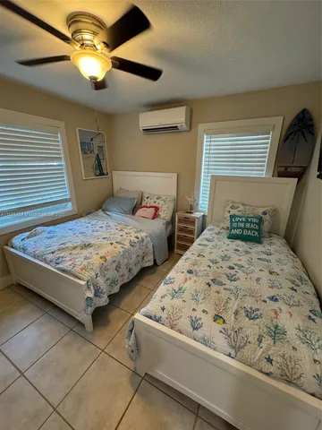 a bedroom with bed and mirror