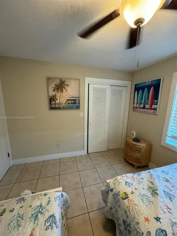 a bedroom with a bed and painting on the wall