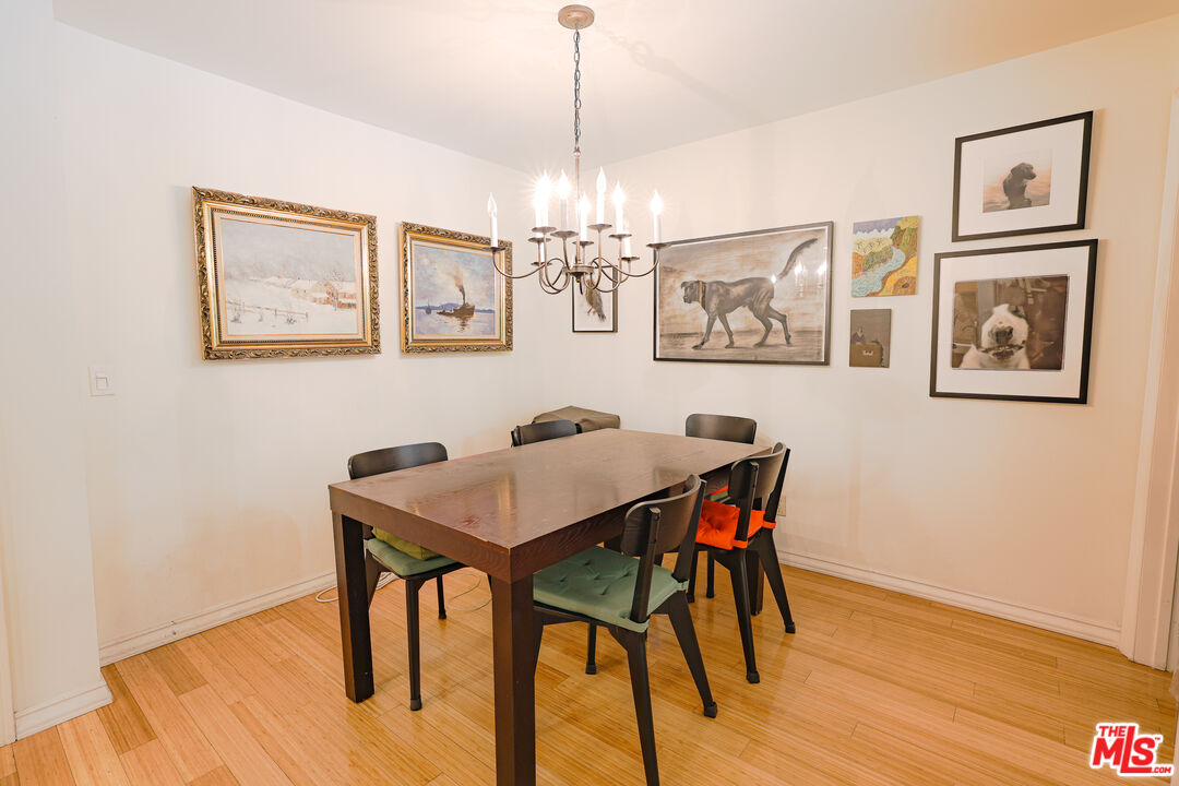 8105 Raintree Circle Culver City, CA 90230 - Photo 6 of 17 a view of a dining room with furniture wooden floor and chandelier