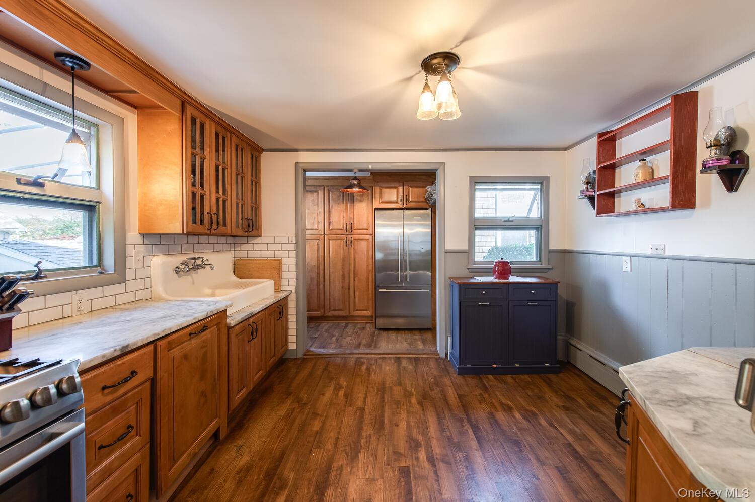 21 Prospect Street Brewster, NY 10509 - Photo 14 of 47 a kitchen with granite countertop a refrigerator a sink dishwasher a stove and white countertops with wooden floor