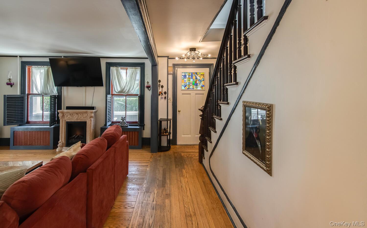 21 Prospect Street Brewster, NY 10509 - Photo 20 of 47 a living room with furniture a fireplace and a flat screen tv