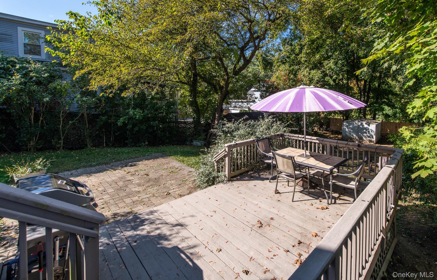 21 Prospect Street Brewster, NY 10509 - Photo 38 of 47 a patio with wooden floor a yard a table and chairs