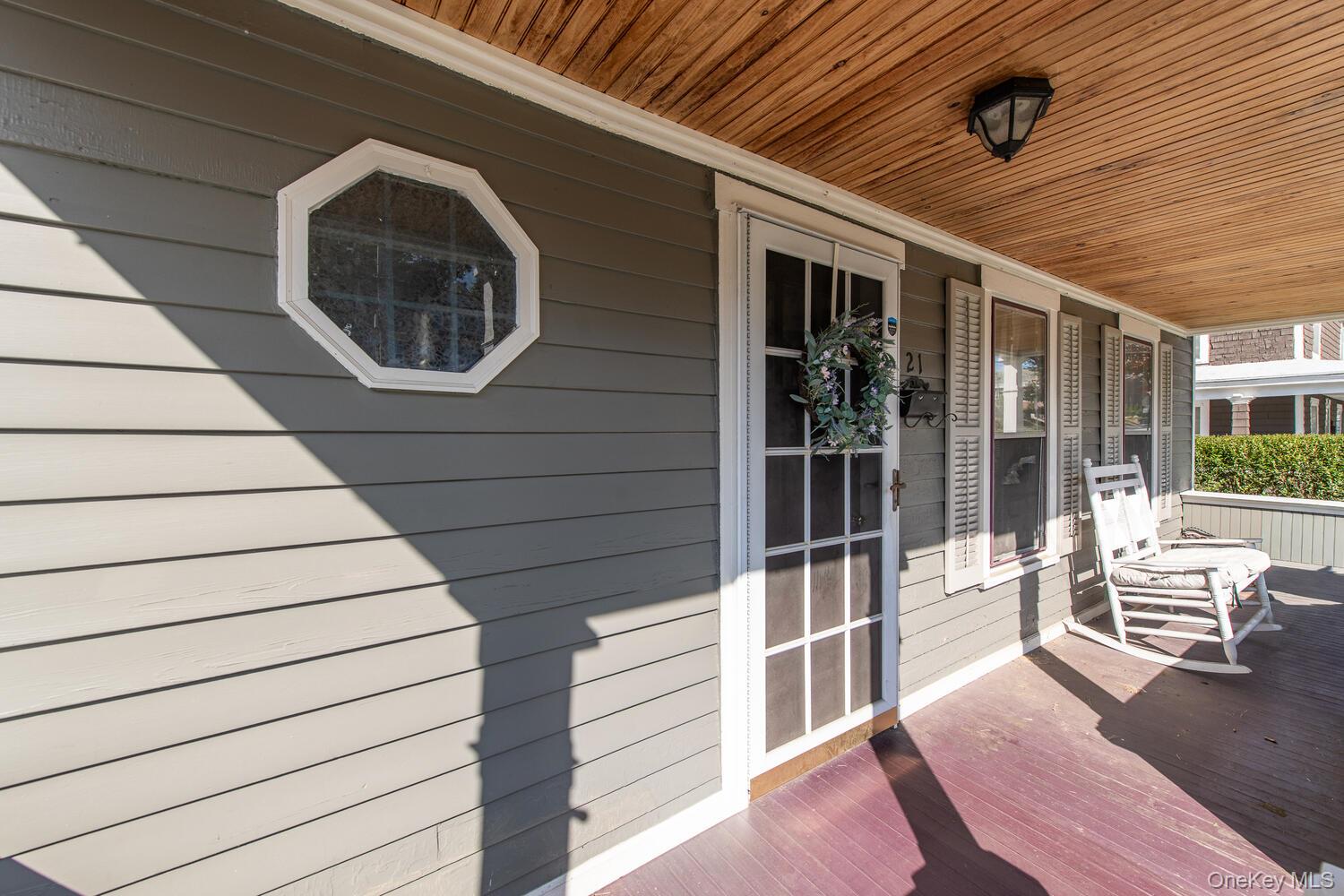21 Prospect Street Brewster, NY 10509 - Photo 4 of 47 a view of a porch with wooden floor and iron stairs