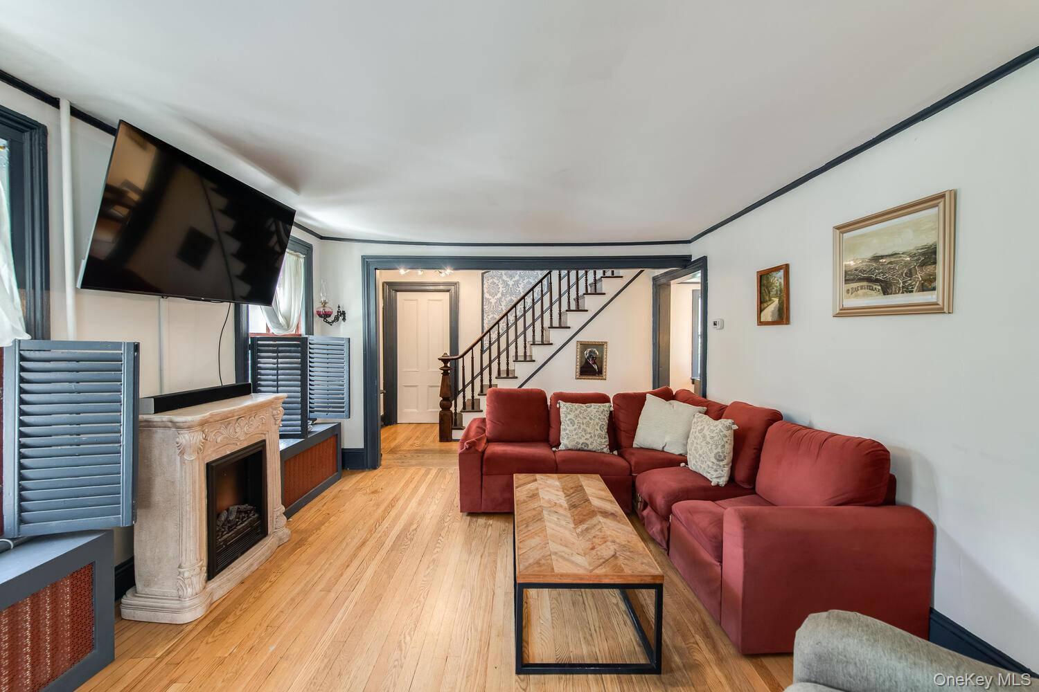 21 Prospect Street Brewster, NY 10509 - Photo 8 of 47 a living room with furniture a flat screen tv and a fireplace