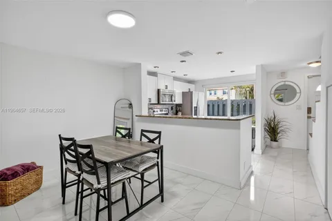 a kitchen with a table and chairs in it