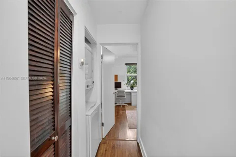 a view of hallway with wooden floor