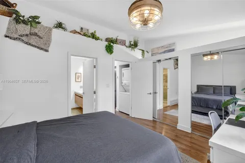 a spacious bedroom with a bed and a chandelier