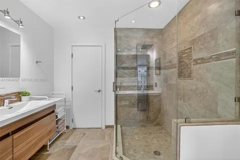 a bathroom with a shower and a sink