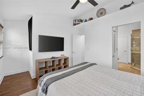 a bedroom with a bed and a flat screen tv