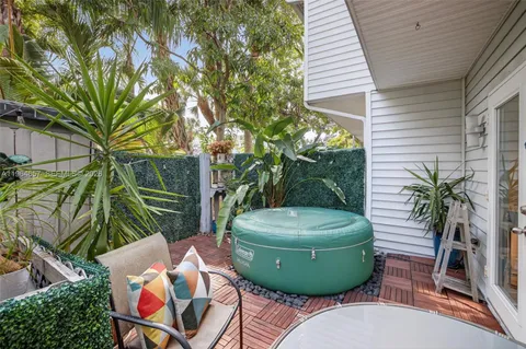a view of a backyard with plants and outdoor seating