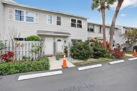 a view of a chair and tables in the back yard of the house