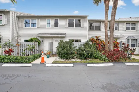 a view of a house with a small yard and a garage