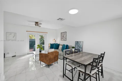 a view of a livingroom with furniture and a dining table