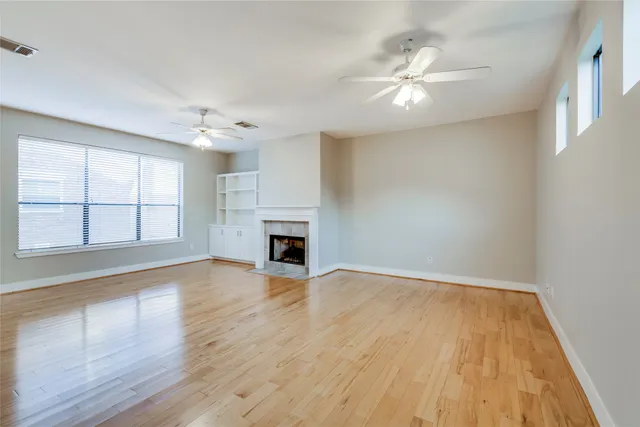 wooden floor in an empty room with a fireplace