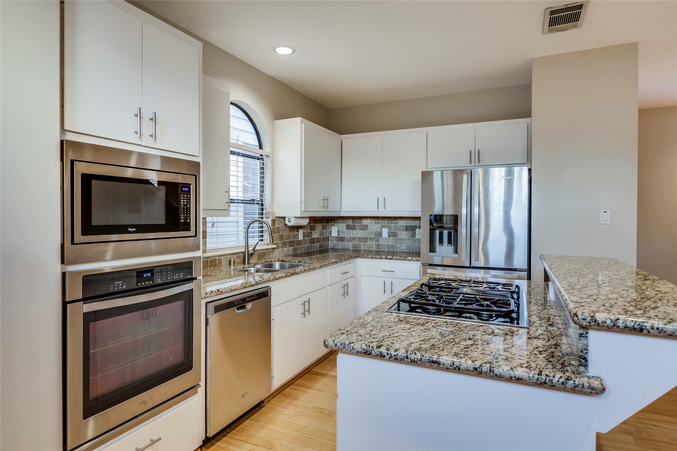 609 Lester Street Houston, TX 77007 - Photo 5 of 31 a kitchen with a sink stove and microwave