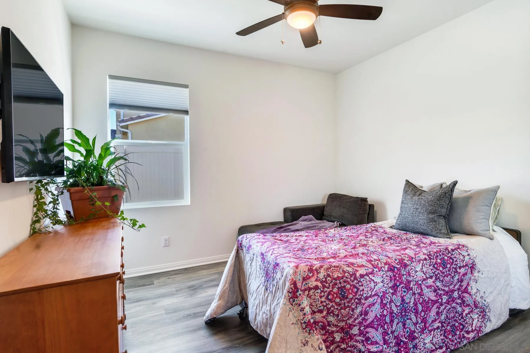 1484 Wicklow Avenue Redlands, CA 92374 - Photo 23 of 35 a bedroom with a large bed and a potted plant