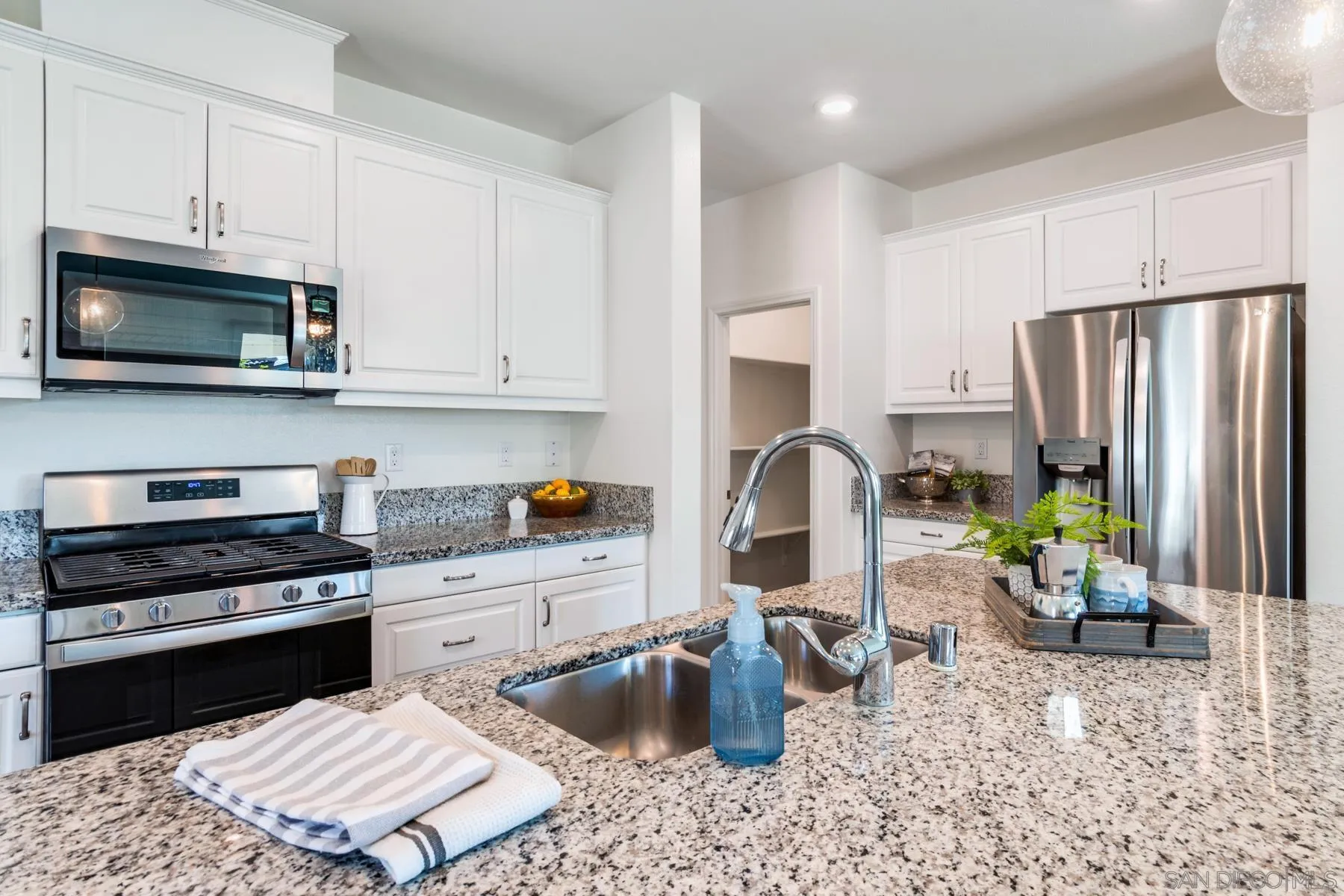 1484 Wicklow Avenue Redlands, CA 92374 - Photo 8 of 35 a kitchen with stainless steel appliances granite countertop a stove refrigerator sink and cabinets