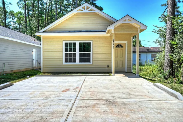 a front view of a house with garden