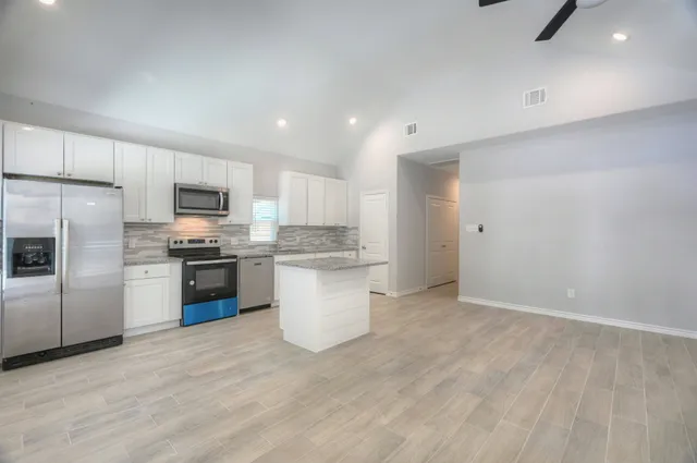 a kitchen with a refrigerator and a sink