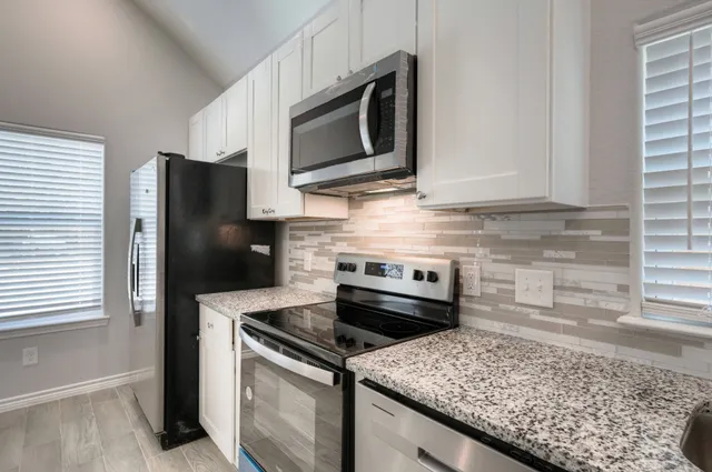 a kitchen with a stove microwave and refrigerator