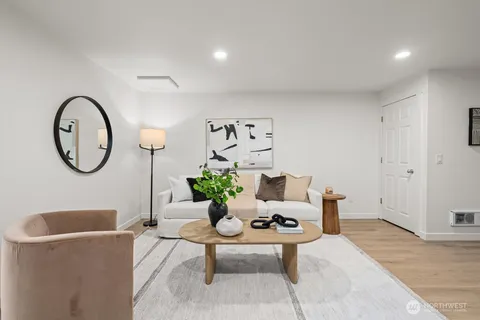 a living room with furniture a mirror and a lamp
