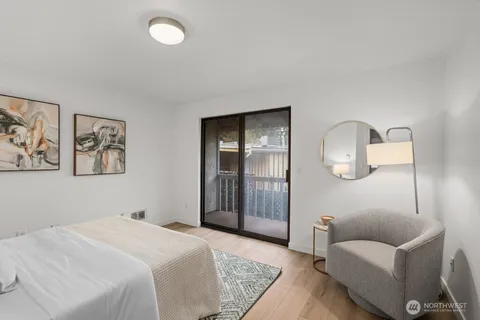 a bedroom with a bed couch and painting on the wall