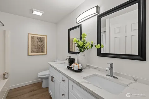 a bathroom with a double vanity sink and a mirror