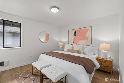 a bedroom with a bed and a lamp