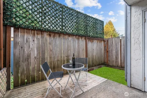 a backyard of a house with table and chairs