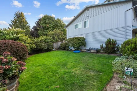 a view of a house with a backyard