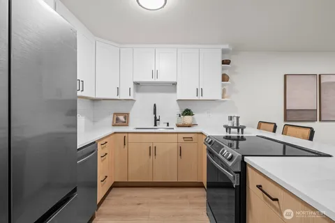 a kitchen with a sink stove and cabinets