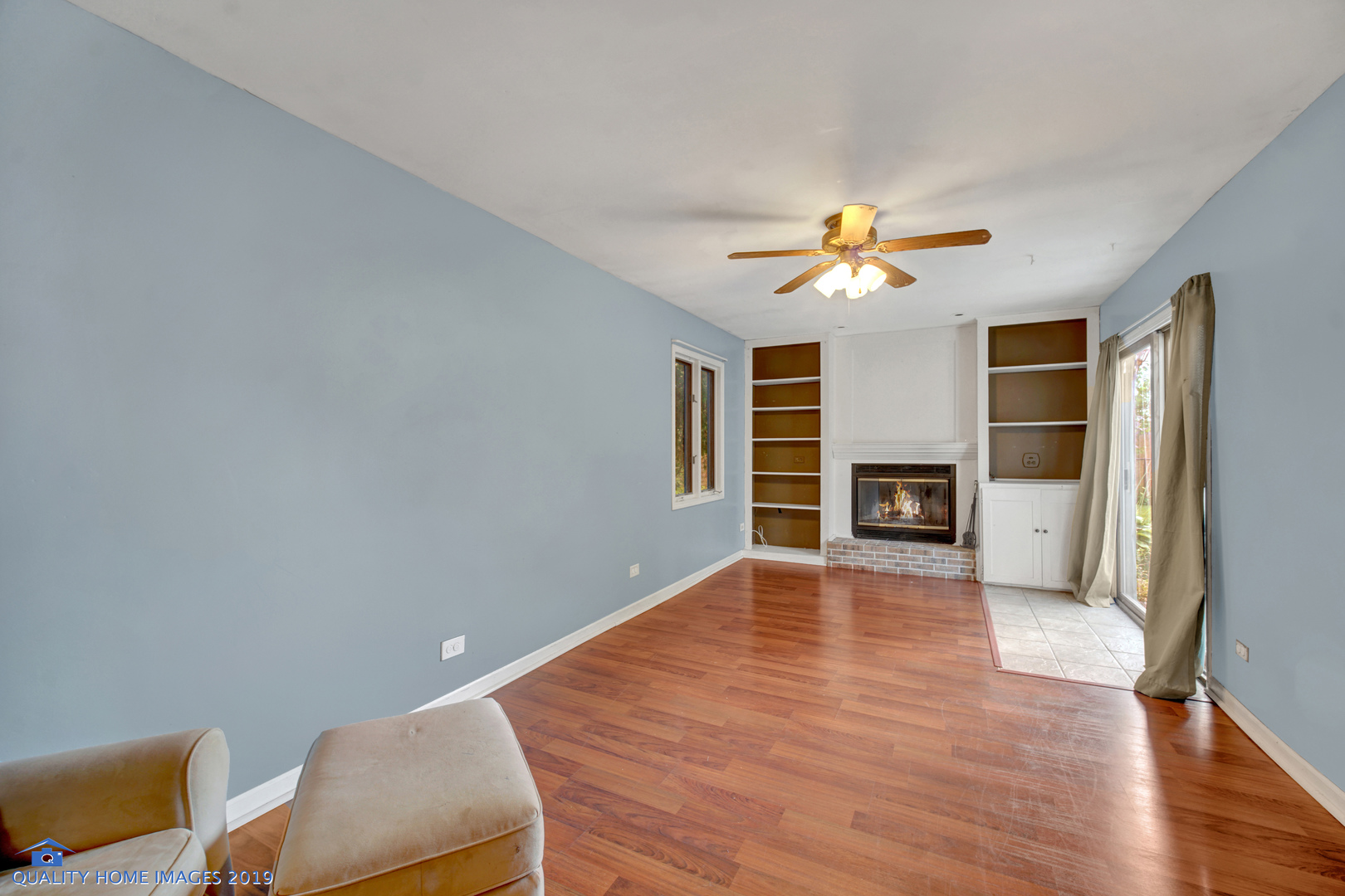 27W241 Churchill Road Winfield, IL 60190 - Photo 8 of 24 a view of an empty room with a fireplace and a window