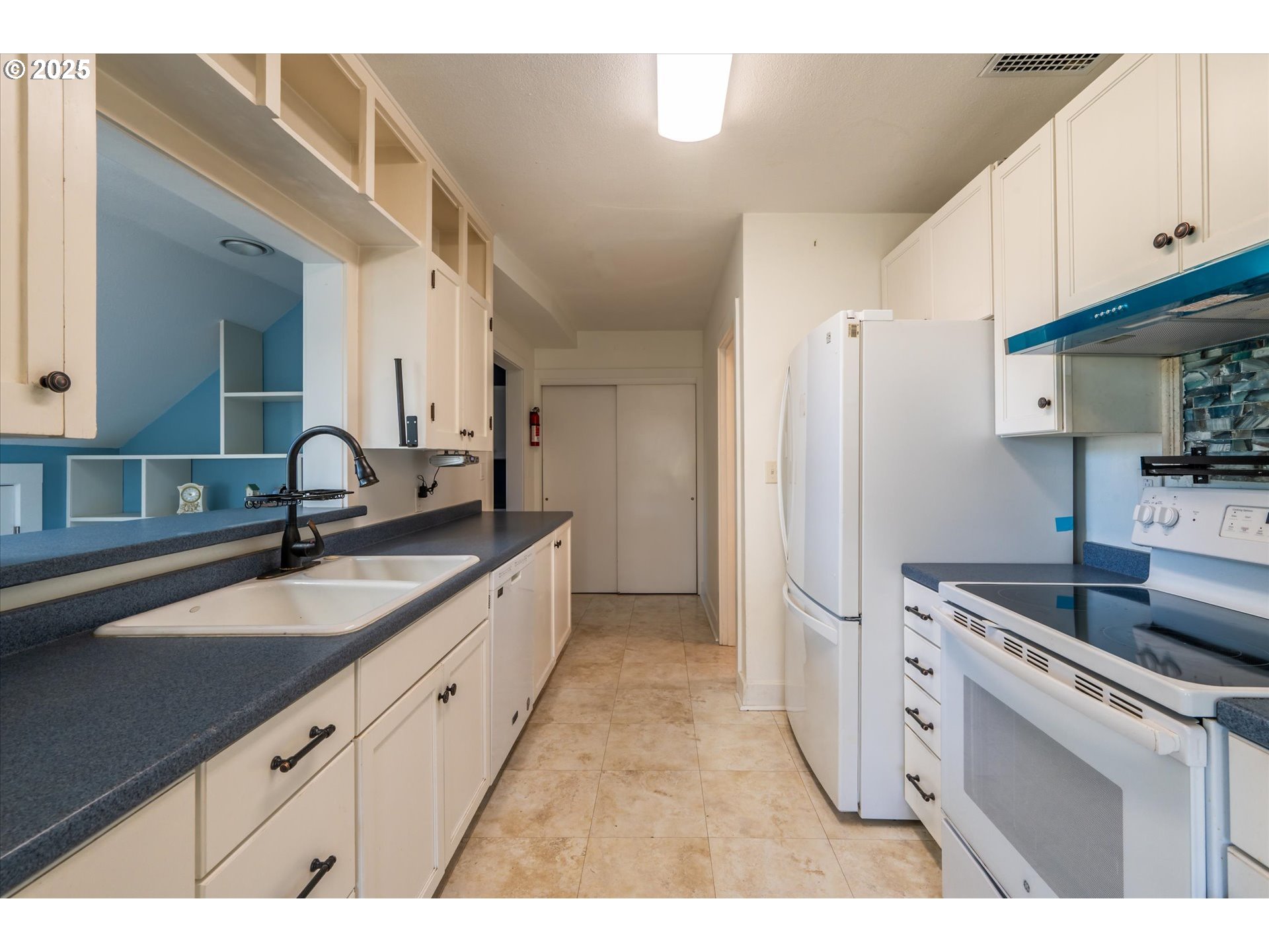 2318 Liberty Street North Bend, OR 97459 - Photo 21 of 29 a kitchen with granite countertop a sink stove and refrigerator