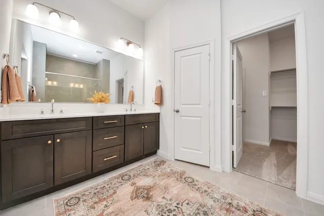 a spacious bathroom with a sink and a mirror