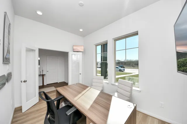 a view of a dining room with a table and chairs